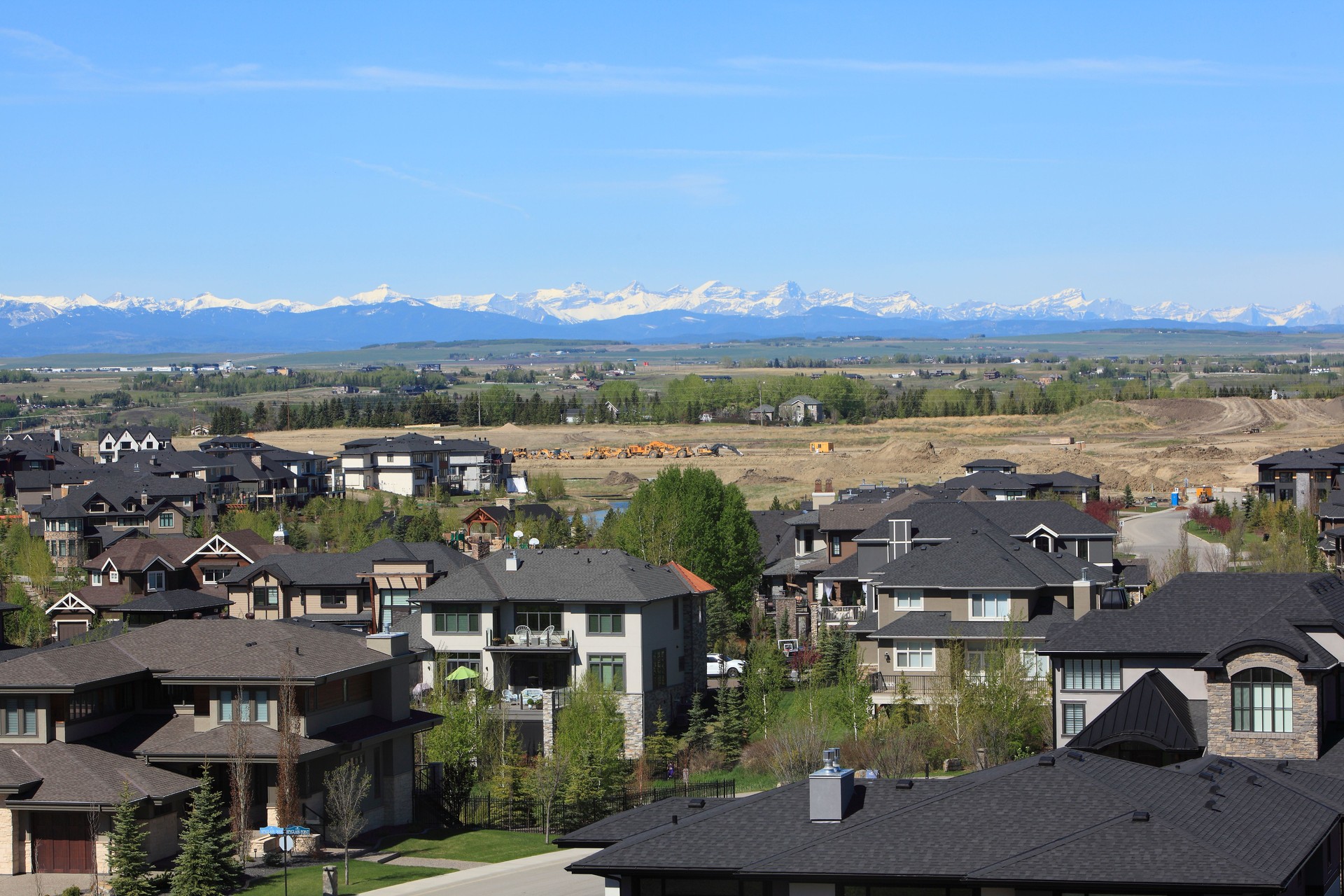 Construction Of Large Residential Homes Bordering On Farmland,Foothills And Mountains